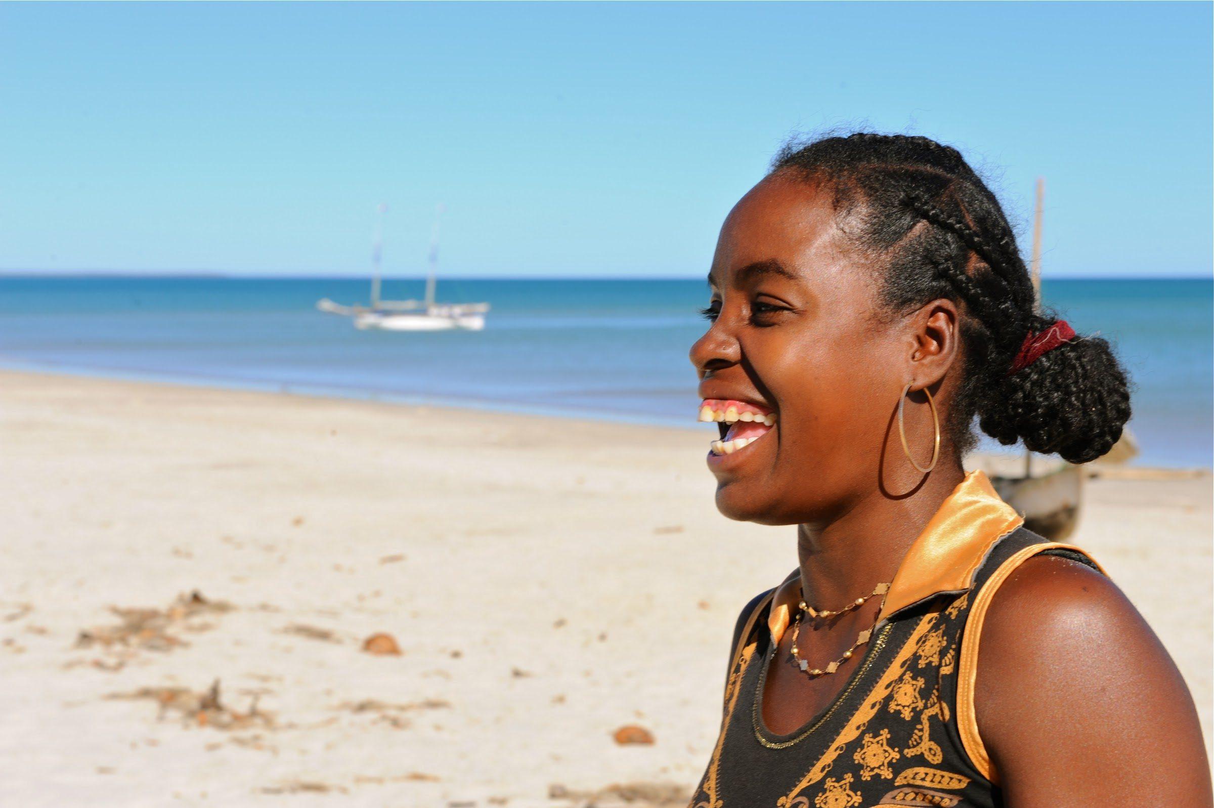 A woman laughing on the beach at Anjajavy