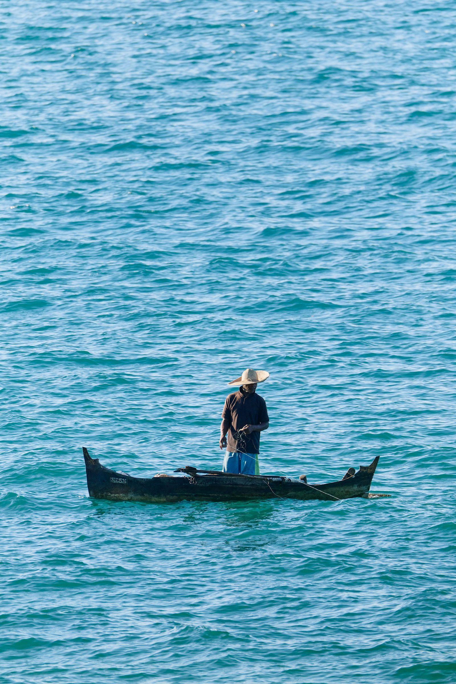 A fisherman standing in his pirogue